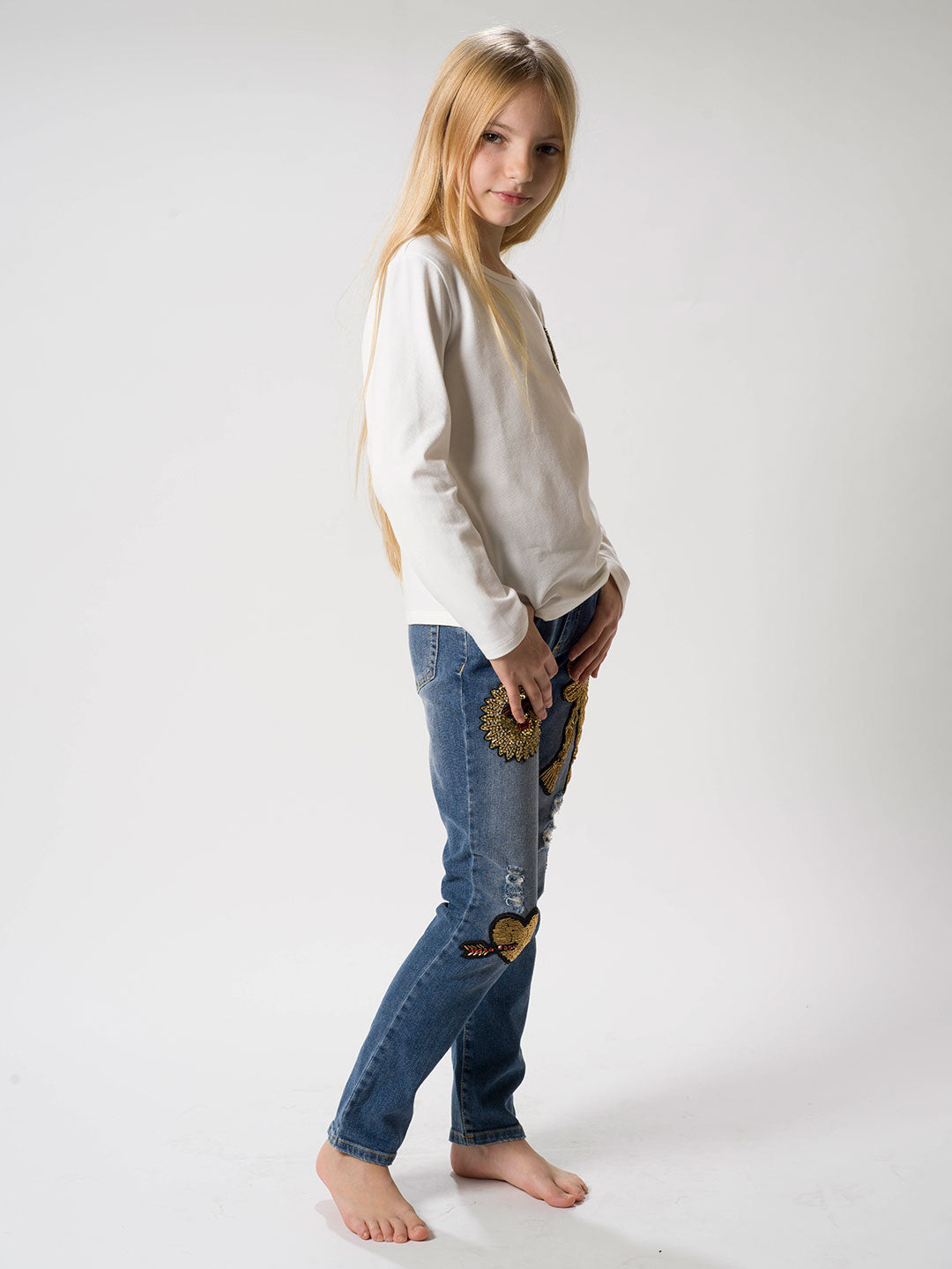 Jeans con applicazioni dorate